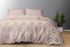 A king size bed sheet set with pillow covers displayed on a bed, with a floral pattern and a pink color scheme.